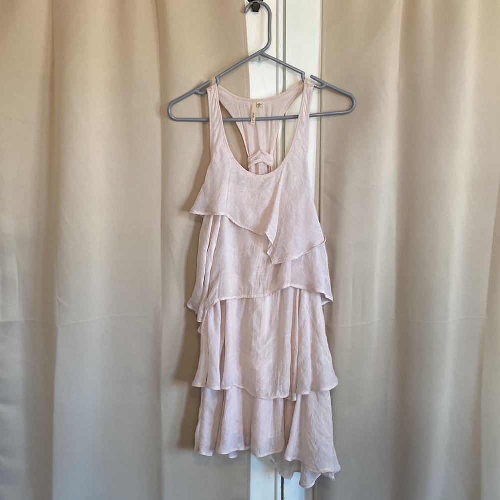 Very cute tiered and flowy blush (not pink) dress with tie detail in back.